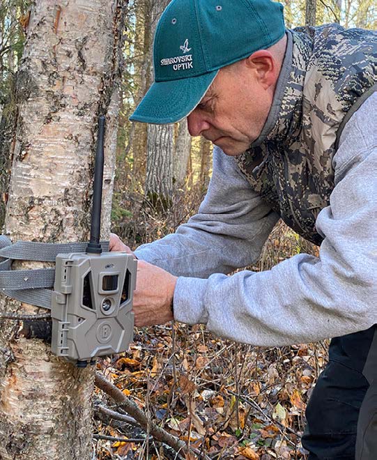hunter installing one of his trail cams