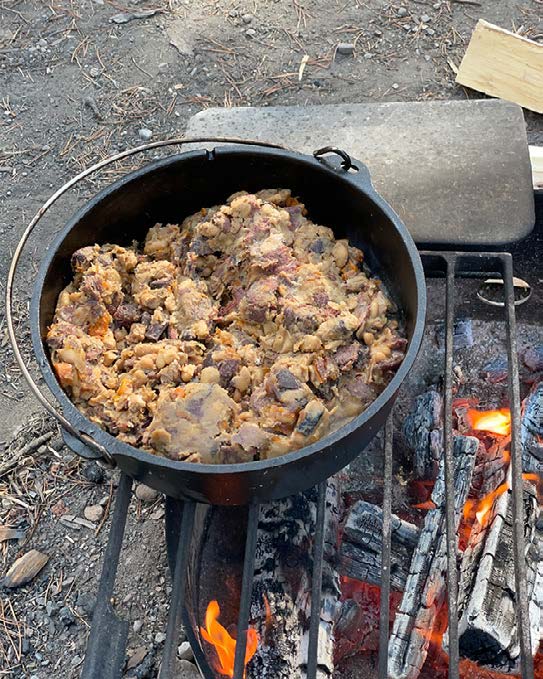 Dutch oven with cooked outdoor meal.