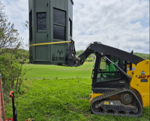 Using a skid steer to set up a12 Point Hunting Stand