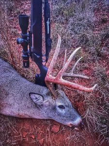 A tall tined whitetail buck taken with a Traditions Nitrobolt muzzleloader