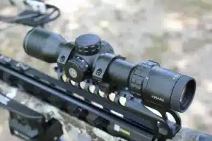 crossbow-mount-768x512jpeg - North American Deer Hunter Black Hawke rifle scope mounted on a rifle, showing adjustment turrets and magnification ring in close-up on a tactical rail.
